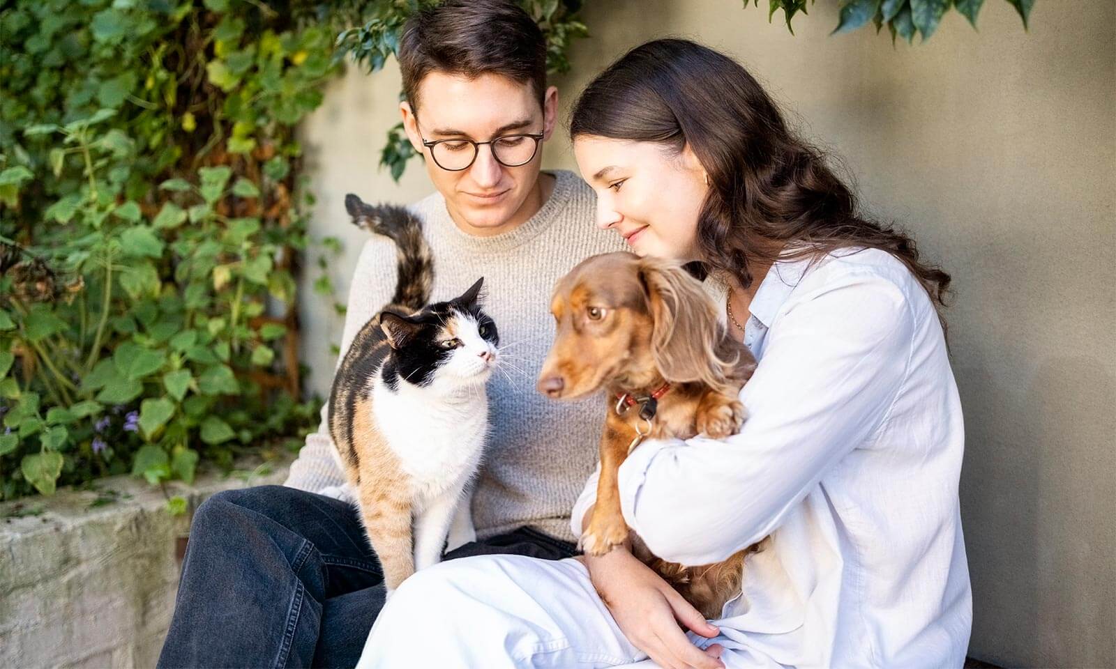 A couple with their cat and dog